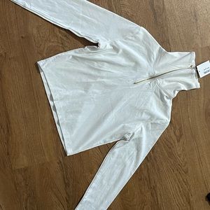 Long sleeve crop top. Can be worn with zipper down.